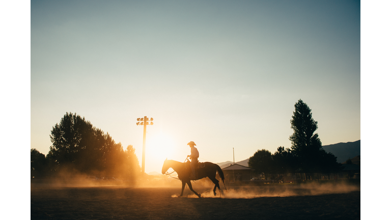 Cowboy Horseback riding at rodeo arena