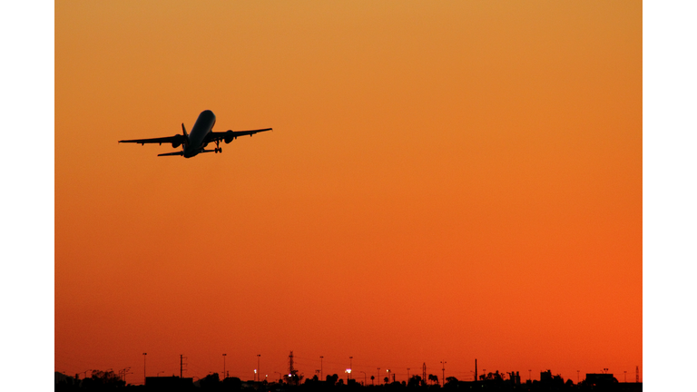 An airplane takes off at sunset from Phoenix Sky Harbor International Airport