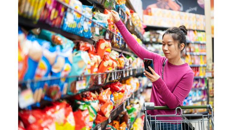 asian female shopping in supermarket