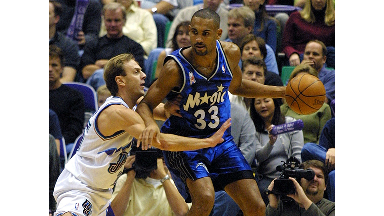 John Crotty (L) of the Utah Jazz is defended by Gr