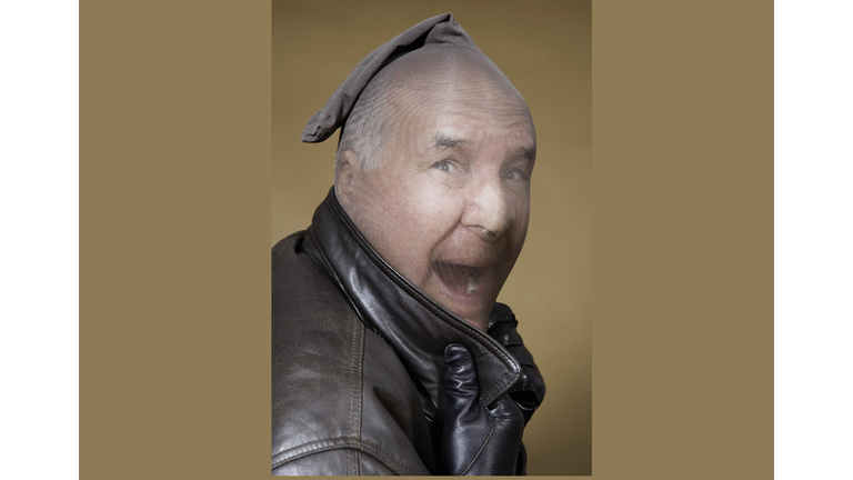 Mature man wearing stocking on head, shouting, portrait
