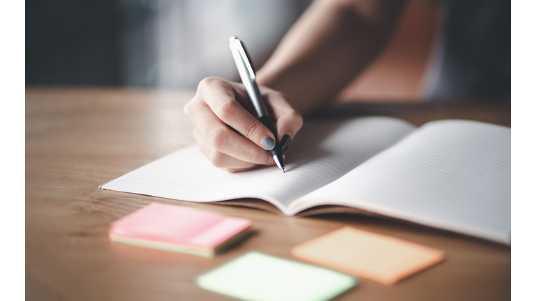 Business woman working at office with documents on his desk, Business woman holding pens and papers making notes in documents on the table, Hands of financial manager taking notes