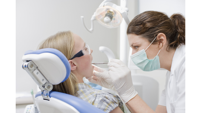 Dental hygienist working on patients teeth