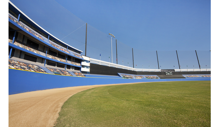 A baseball stadium with grass and dirt outfield