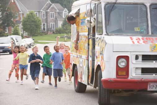 Children (4-8) running towards ice cream truck