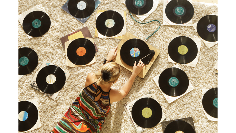 Woman on floor playing records