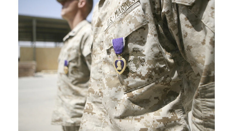 Machine gunners with Security Platoon, Combat Logistics Company 117, Combat Logistics Battalion 7, 1st Marine Logistics Group (Fwd), stand at the position of attention with their Purple Heart awards.