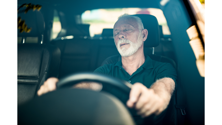 Senior man falls asleep while driving.
