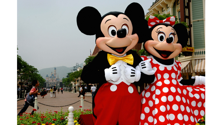Mickey and Minnie Mouse walk around the