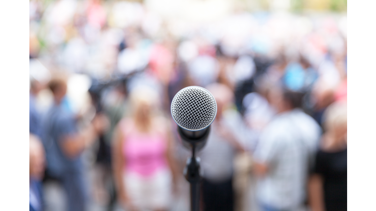 Close-Up Of Microphone Against Crowd