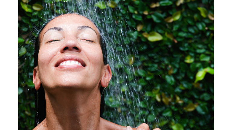 Smiling colored woman in the shower