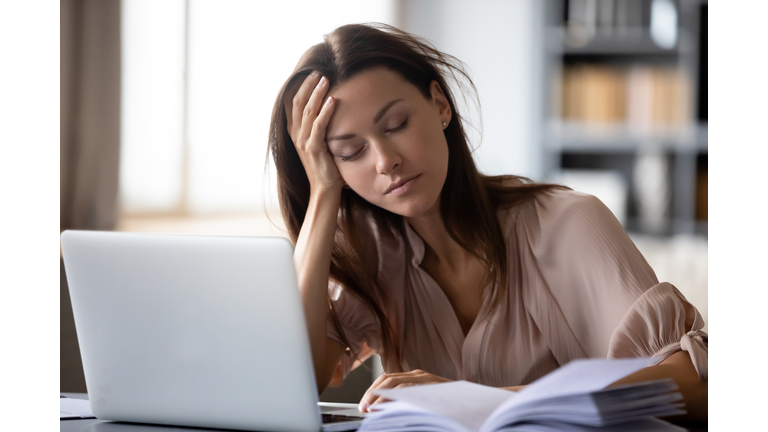 Tired young woman fall asleep working at laptop