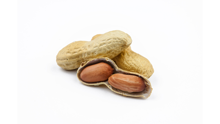 Close-Up Of Peanuts Against White Background