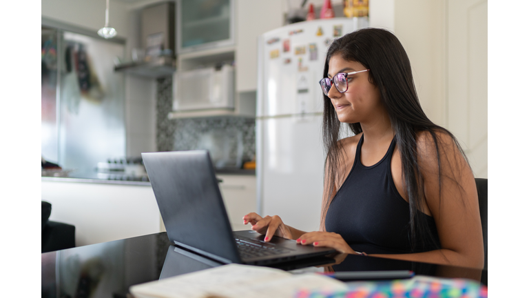 Young woman using laptop at home