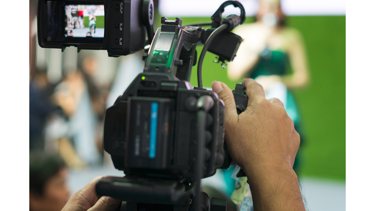 Man Filming People Through Television Camera.Videoand shoot video concept.
