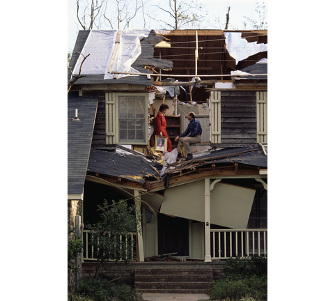 Couple Sitting in Their Damaged House