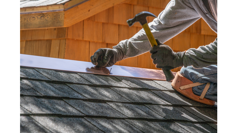 Man installing asphalt roof