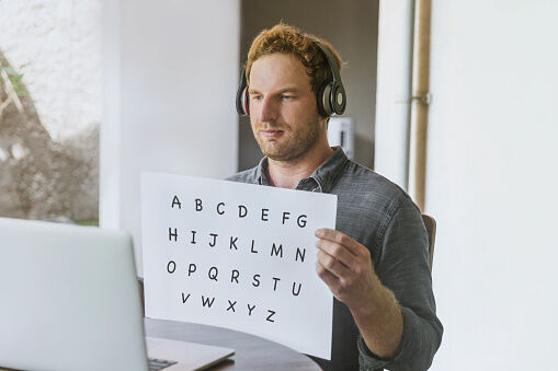 Kindergarten teacher teaching basic alphabet from home.