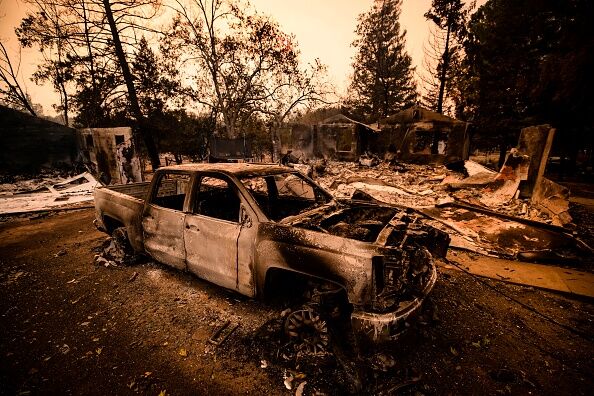 US-FIREhe carcass of a burned car is seen next next to a house reduced to ashes by the Glass Fire in Napa Valley, California on September 28, 2020.