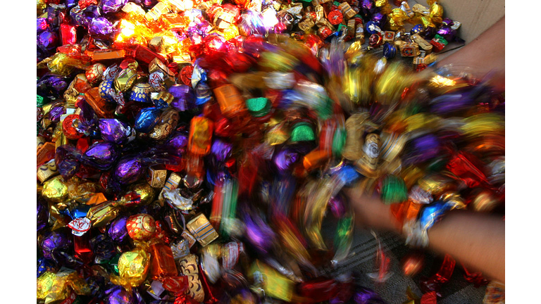 A vendor scoops out wrapped sweets at hi