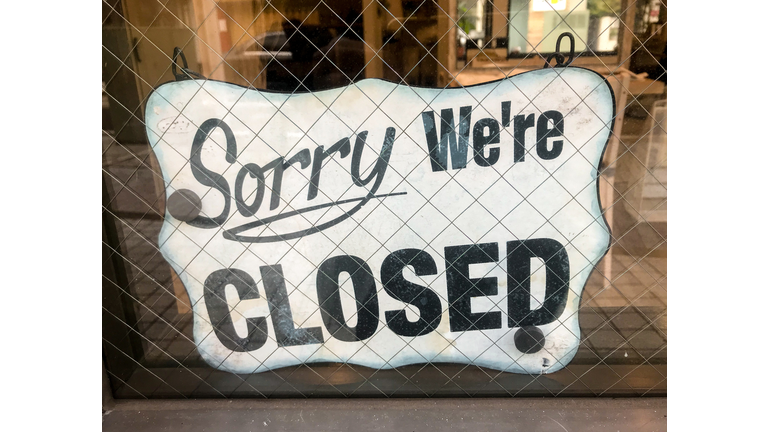 English closed sign hanging in window
