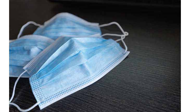 Respiratory mask on desk in office, Protective medical mask with 2019-nCoV, Coronavirus protection concept.