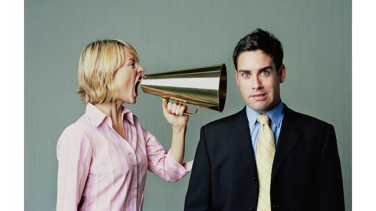 Woman shouting at men with phone