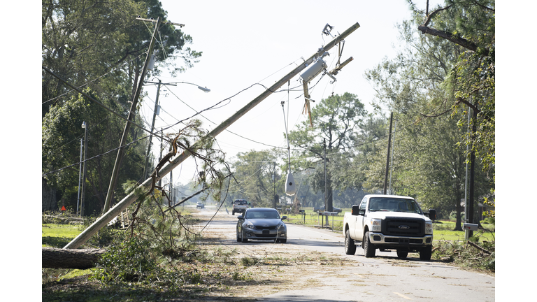 Cars avoid fallen utility poles after Hurricane Delta passed through the area on October 10, 2020 in Jennings, Louisiana. (Photo by Go Nakamura/Getty Images)