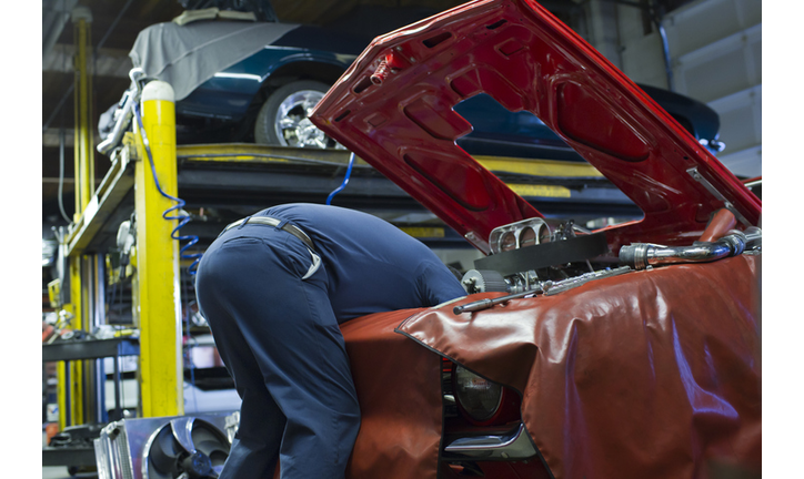 Mechanic works deep inside engine