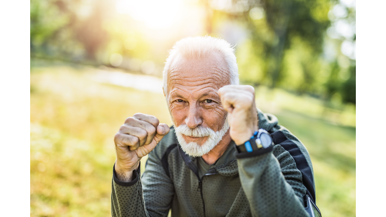 Sporty senior man loves boxing and is stronger than ever.