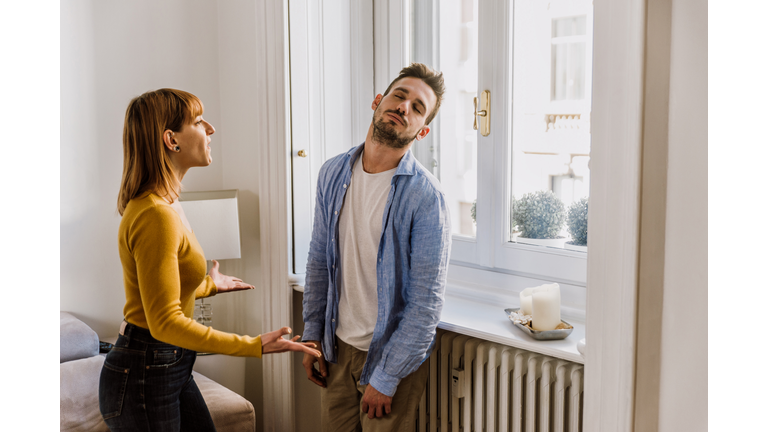 Young Couple Arguing While Standing At Home