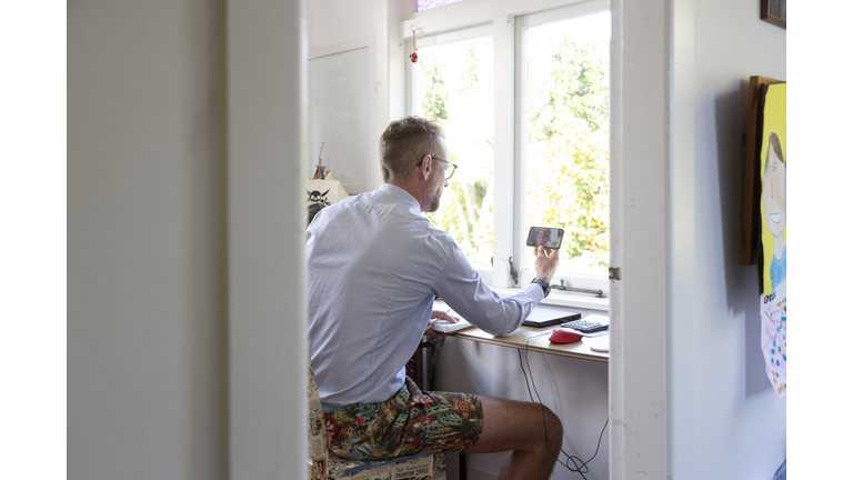 Man working from home in a makeshift office in a child's bedroom