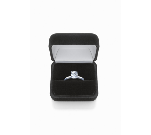 Diamond ring in box, against white background, close-up