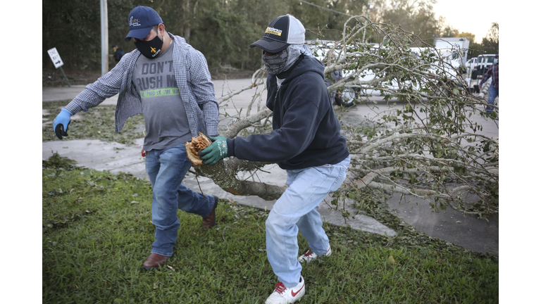 Workers clear debris from Hurricane Zeta at St Bernard Middle School on October 29, 2020 in St Bernard, Louisiana. A record seven hurricanes have hit the gulf coast in 2020 bringing prolonged destruction to the area. (Photo by Sandy Huffaker/Getty Images)