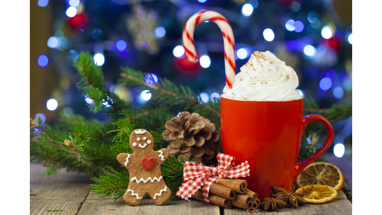Christmas cappuccino and gingerbread cookies infront Christmas tree