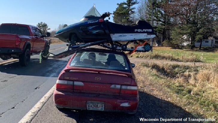 Cop Stops Car with Snowmobile on Roof