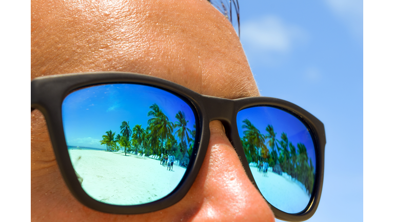 Close-Up Of Man Wearing Sunglasses At Beach During Sunny Day