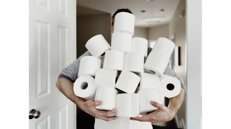 Man Carries Heap of Toilet Paper