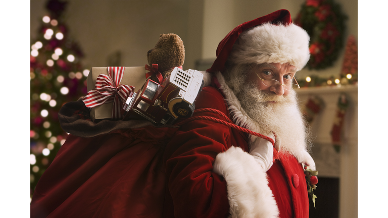 Santa Claus carrying sack of gifts, portrait, close-up