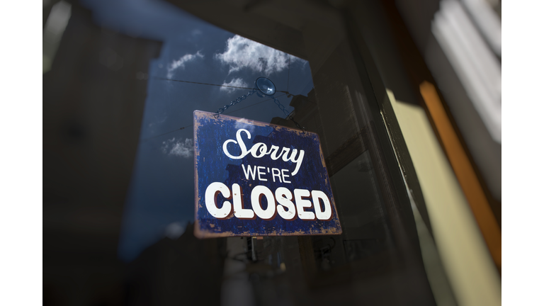 Closed sign on the front door of a shop