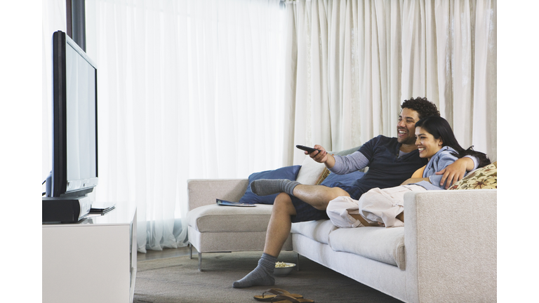 couple watching tv in their home