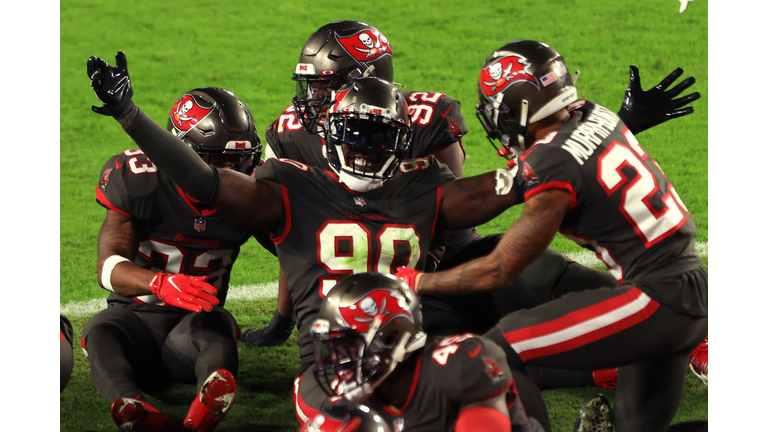 Jason Pierre-Paul celebrates with his teammates after his third-quarter interception of Jared Goff Monday night against the Los Angeles Rams