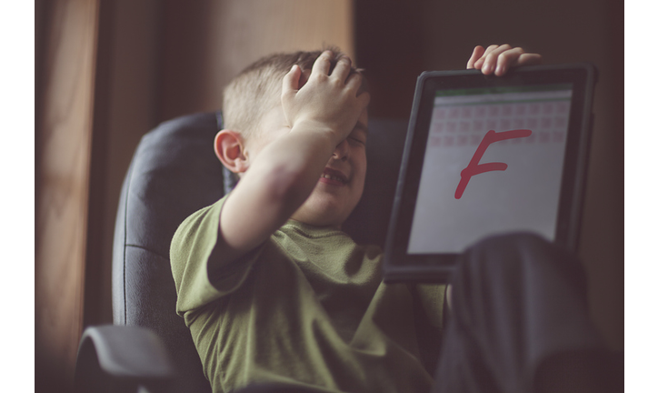 boy showing failing grade on electronic tablet