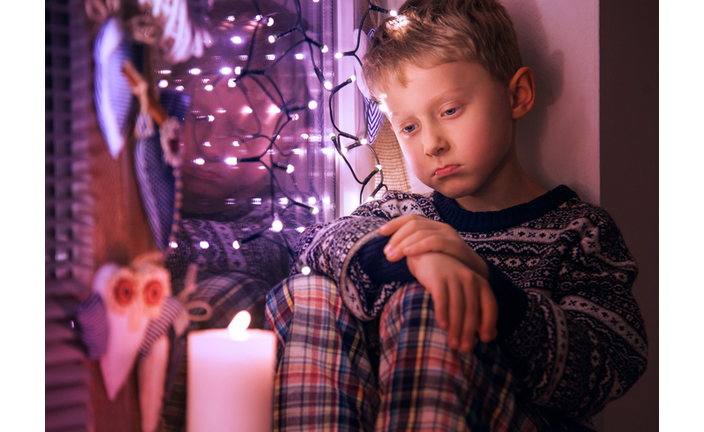 Sad Little boy waiting for Christmas presents