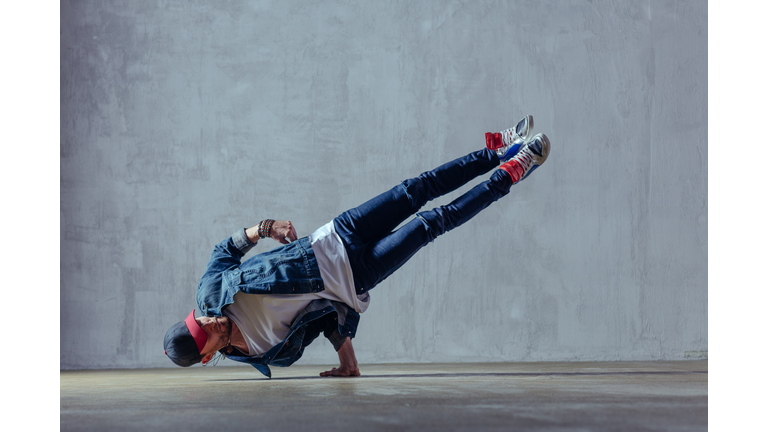 Young beautiful male dancer posing in studio