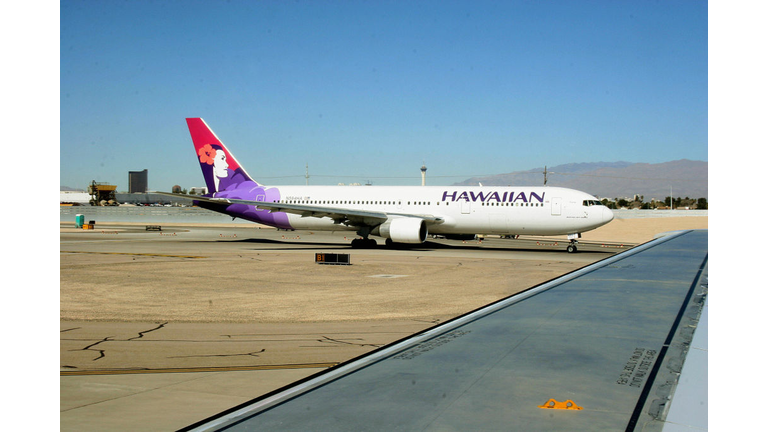 A Hawaiian Airlines jet taxies out to th