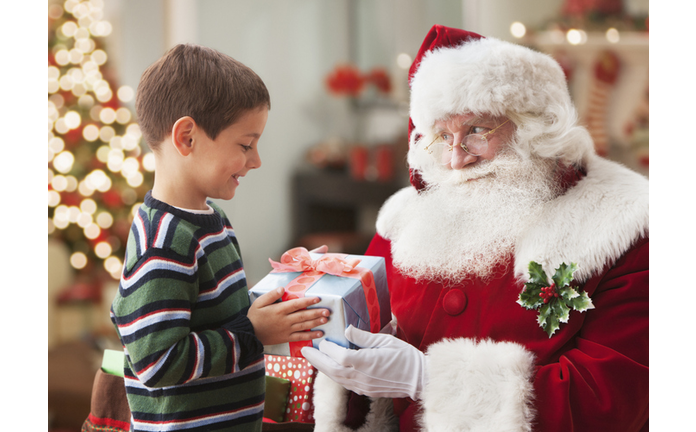 Santa giving Caucasian boy Christmas gift