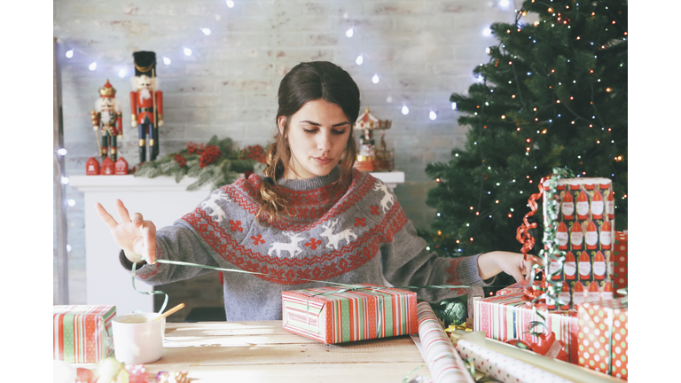 Woman wrapping christmas gifts