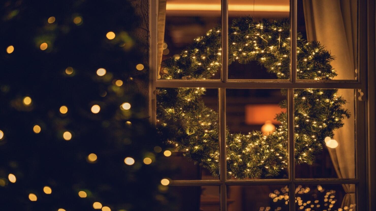 View through a window of a Christmas wreath in a living room