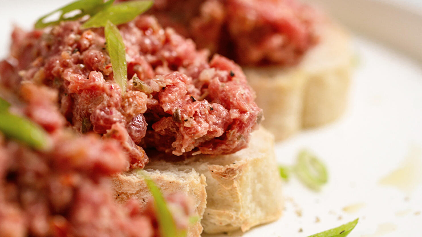 Tasty Italian appetizers bruschetta with meat.